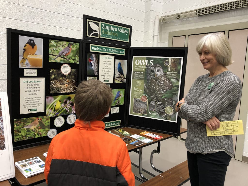 Nomad discussing area birds with the display by the Zumbro Valley Audubon society
