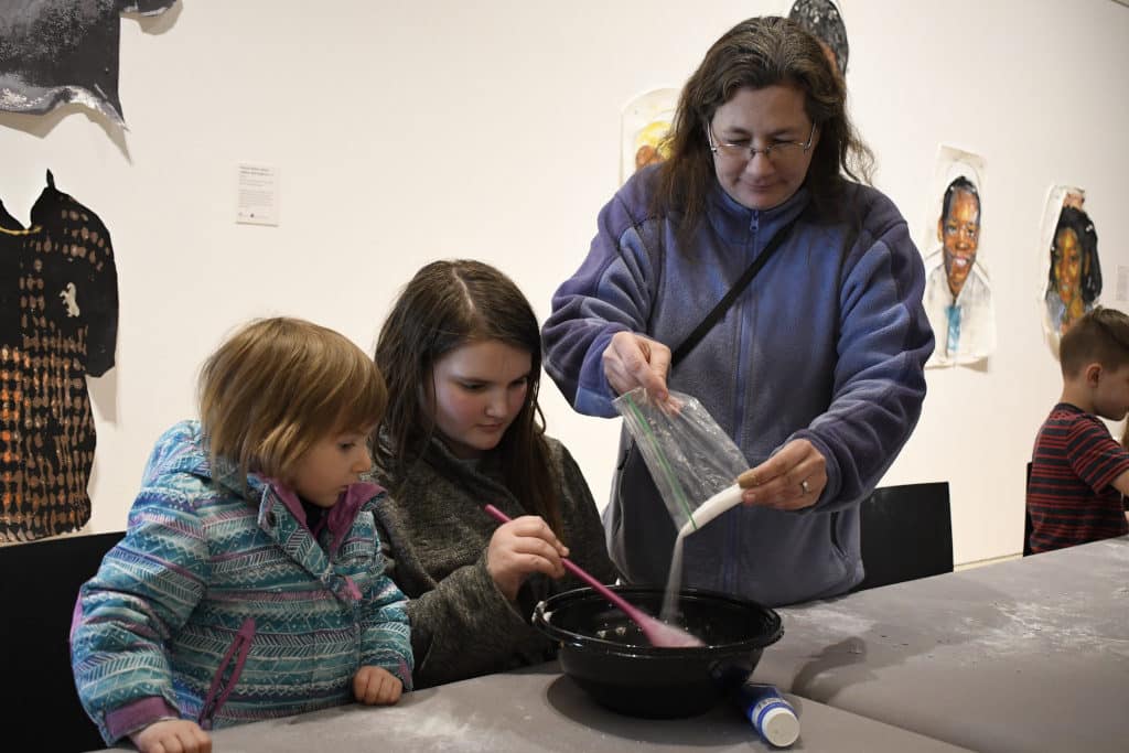 Family making playdough at the Erie Art Museum