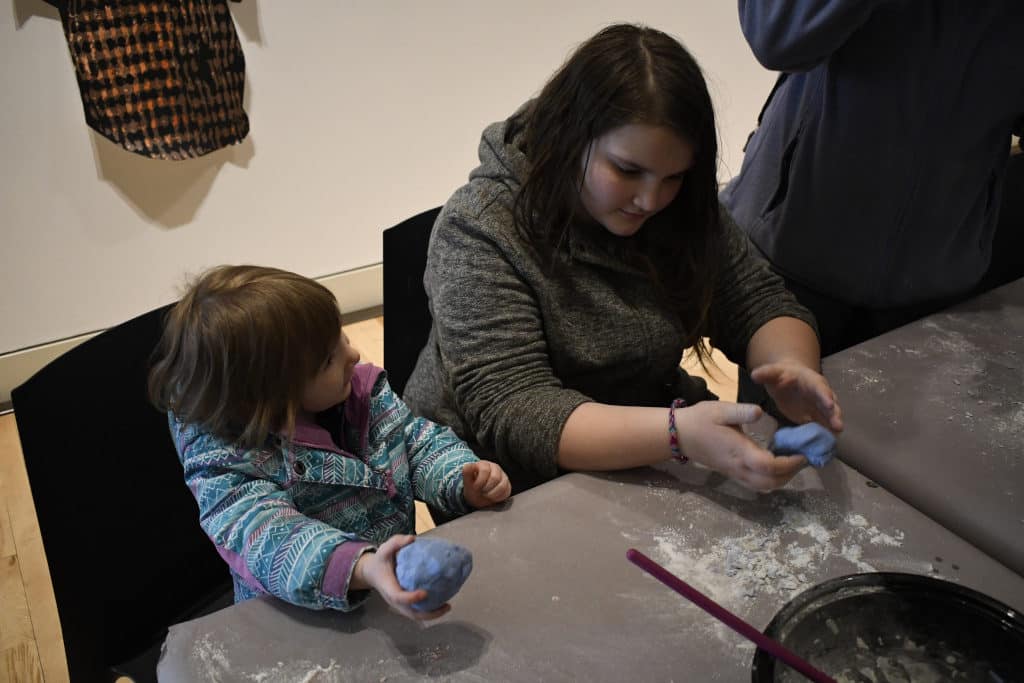 Girls testing playdough at the Erie Art Museum